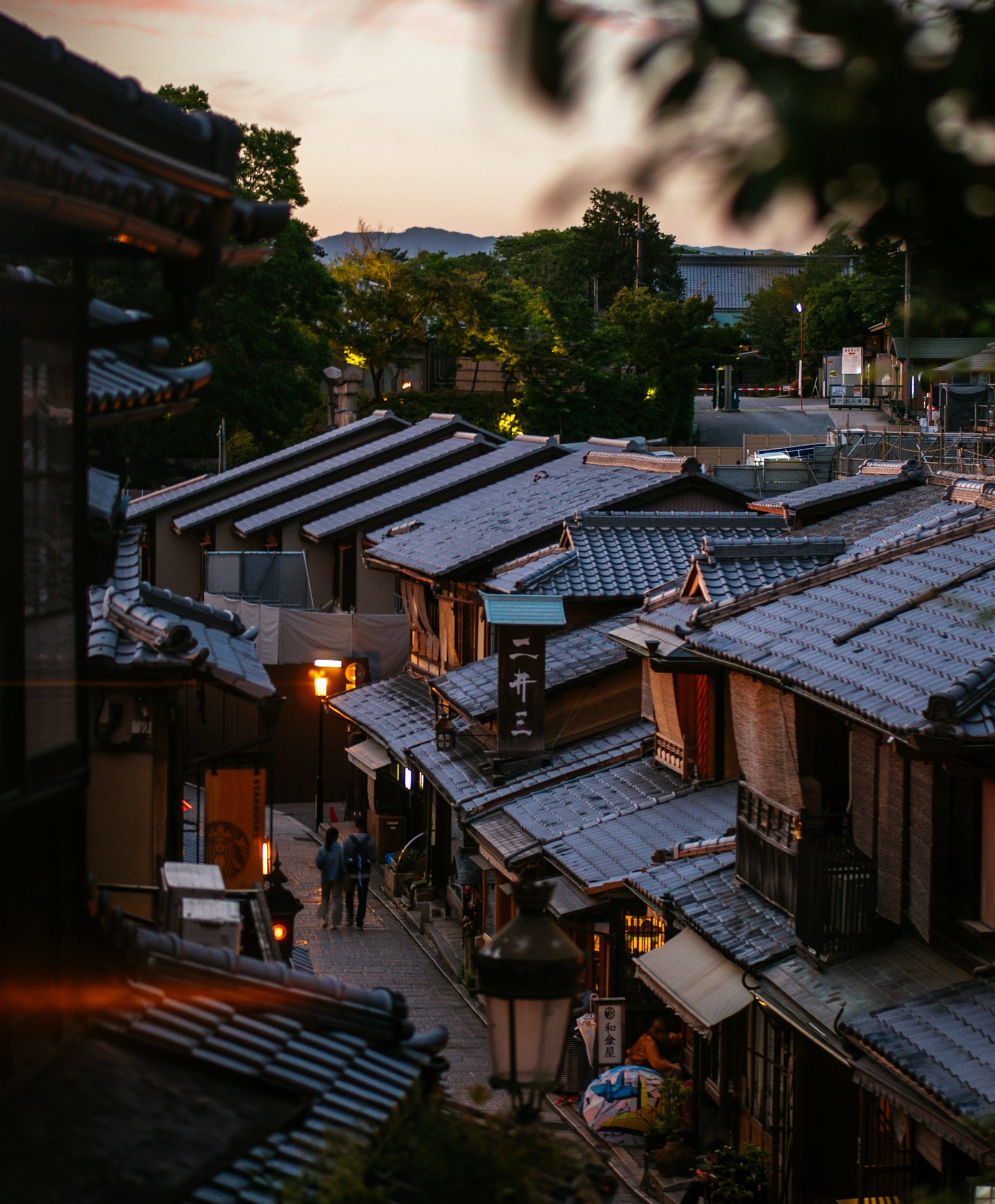 A quiet lantern-lit lane in old Kyoto, Japan at dusk