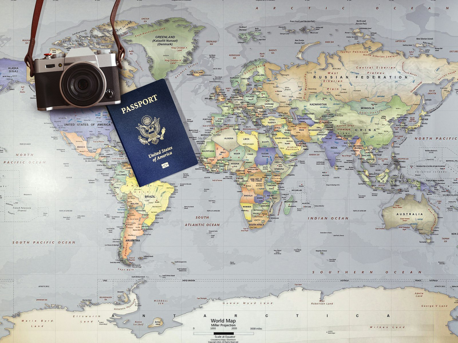 An Orbis travel planner reviewing a printed world map and route notes at a desk